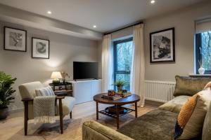 a living room with a couch and a table at 34 Ironworks in Backbarrow