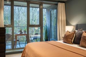 a bedroom with a bed and a large window at 34 Ironworks in Backbarrow