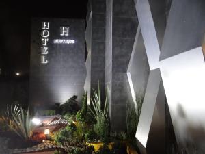 a building with a sign on the side of it at H Boutique Touca in Toluca