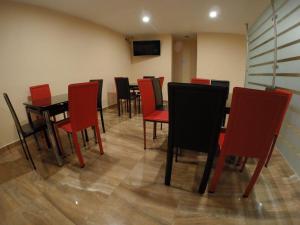 a dining room with red chairs and a table at H Boutique Touca in Toluca