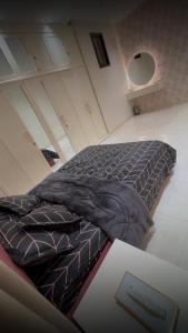 a bed with a blanket on the floor in a room at ستارز هاوس in Najran