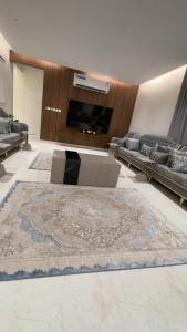 a living room with a large rug on the floor at ستارز هاوس in Najran