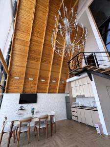 a dining room with a chandelier and a table and chairs at Luxury A-Frame Forest Chalet in Gabala