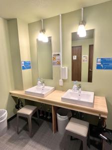 a bathroom with two sinks and two mirrors at Otemachi Kamon Hotel in Tokyo +36 photos
