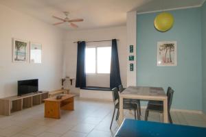 a living room with a table and a television at aparthotelboavista-net in Sal Rei +17 photos