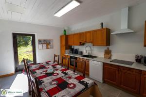 a kitchen with a table with a table cloth on it at "Gîte de Bel Horizon" in Broquiès
