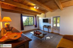 a living room with a couch and a table at "Gîte de Bel Horizon" in Broquiès