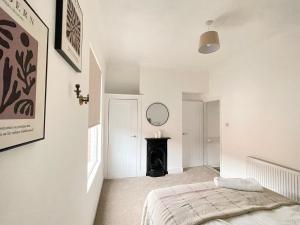 a bedroom with a bed and a mirror on the wall at 3 Bed plus Sofa sleeps 6 central in Middlesbrough
