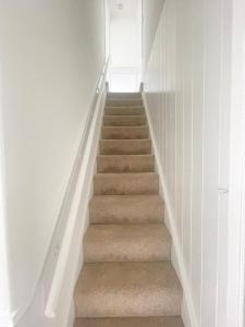 a stairway with a stair case in a house at 3 Bed plus Sofa sleeps 6 central in Middlesbrough +1 photo