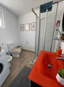a bathroom with a shower and a washing machine at Heritage House Malonas in Malona Village +10 photos