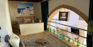 a living room with an archway in a room with a fireplace at Heritage House Malonas in Malona Village