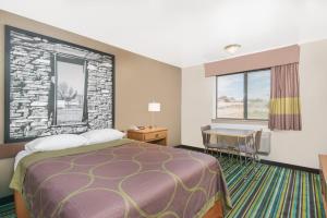 a hotel room with a bed and a desk at Super 8 by Wyndham Santa Rosa in Santa Rosa