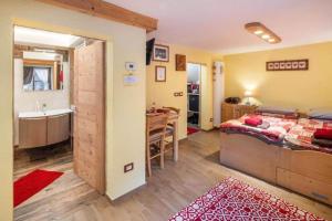 a bedroom with a bed and a sink and a bathroom at Ciesa del Selmo Faure in Sottoguda