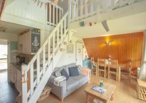 a living room with a couch and a table at Chalet Three in Deal
