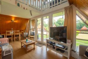 a living room with a flat screen tv and a couch at Chalet Three in Deal
