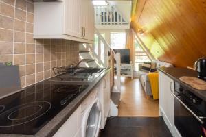 a kitchen with a stove and a dishwasher at Chalet Three in Deal +18 photos
