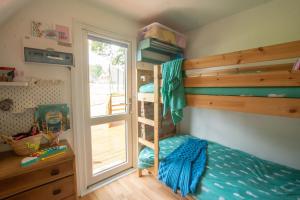 a bedroom with a bunk bed and a window at Chalet Three in Deal