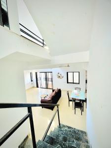 a living room with a couch and a table at ll MOCKTAIL VILLA ll 3BHK ll AC ll PRIVATE POOL ll MALAVALI ll in Lonavala