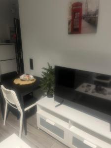 a living room with a table and a television at Zarko Home in Drama