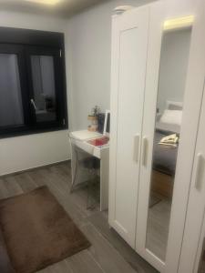 a small room with a desk and a bed at Zarko Home in Drama