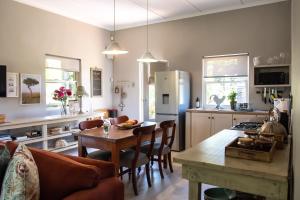 a kitchen and living room with a table and chairs at Kuruma Farm Cottages in Worcester