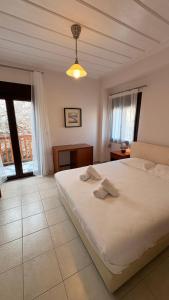 a bedroom with a bed with two towels on it at Kỳma - Stone Luxury Villa in Órmos Koumaíïkon