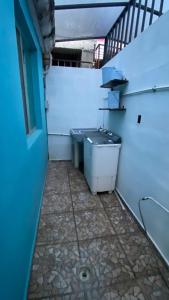 a small bathroom with a sink and a staircase at Casa pequeña in Acapulco