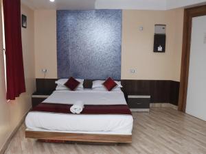 a bedroom with a large bed in a room at Heritage Tezpur in Tezpur
