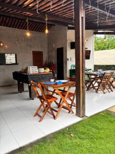 a group of tables and chairs on a patio at Pousada Casa Marelle in Paracuru