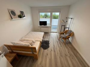 a living room with a bed and a tv at Casa Forest Jump in Pirmasens