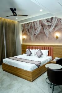 a bedroom with a king sized bed in a room at Hotel Eastleigh in Ludhiana +44 photos