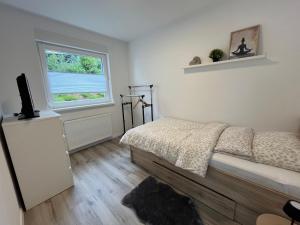 a bedroom with a bed and a window at Casa Forest Jump in Pirmasens