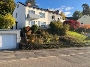 a white house on the side of a street at Casa Forest Jump in Pirmasens