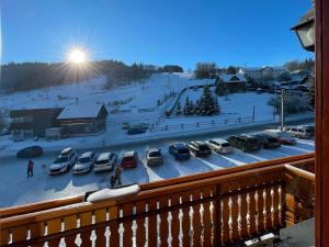 a view of a parking lot with cars in the snow at Penzion Praděd in Malá Morávka