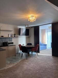 a kitchen and dining room with a table and chairs at Villa Morska Perła in Rewal