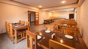 an empty restaurant with wooden tables and chairs at Sumitel Sonam Lachung in Lachung