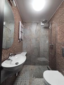 a bathroom with a sink and a toilet and a shower at Villa Morska Perła in Rewal +52 photos