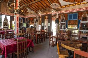 a restaurant with tables and chairs in a room at Pousada Marajoara- Hotel Fazenda-Turismo de Aventura in Soure