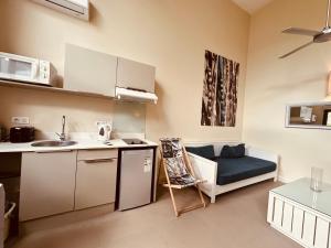 a kitchen with a sink and a couch in a room at Be Cosy Private Villa - Trou aux Biches in Triolet