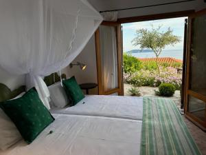 a bedroom with a bed with a view of the ocean at Villa Athena Skiathos in Megali Ammos