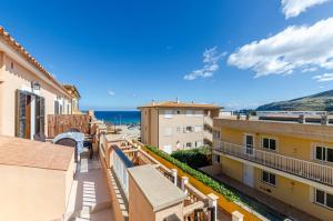 a view of the ocean from the balcony of a building at YourHouse Sol i Mar 1 apartment in Cala Mesquida