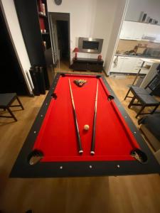 a red snooker table with a ball on it at Chez Jo in Flize