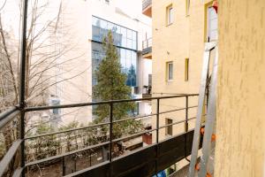 a christmas tree on the balcony of a building at NDK - UrbanLux Medius 2BDR FREE Parking in Sofia