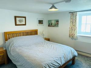 a bedroom with a bed and a window at Kivel Cottage in Portland