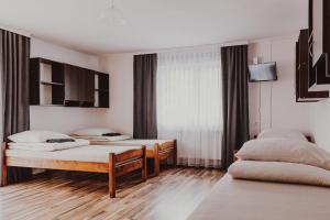 a bedroom with two beds and a window at Dom Wypoczynkowy U STASKA in Ochotnica Dolna +84 photos
