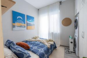 a bedroom with a bed and a washing machine at NDK - UrbanLux Medius 2BDR FREE Parking in Sofia