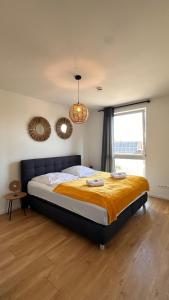 a bedroom with a large bed in front of a window at AMAO-Sepia - Spacious Family Apartment - 6 Guests - Parking in Rheinhausen