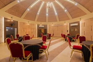 a conference room with tables and chairs and a ceiling at Treebo Premium Mowgli's Den, Pench Tiger Reserve, Turia in Khawāsa