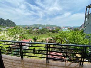 a balcony with a bench and a view of a city at Son Tinh Hotel in Phong Nha