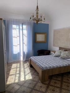 a bedroom with a bed and a chandelier at Annacare in Trapani